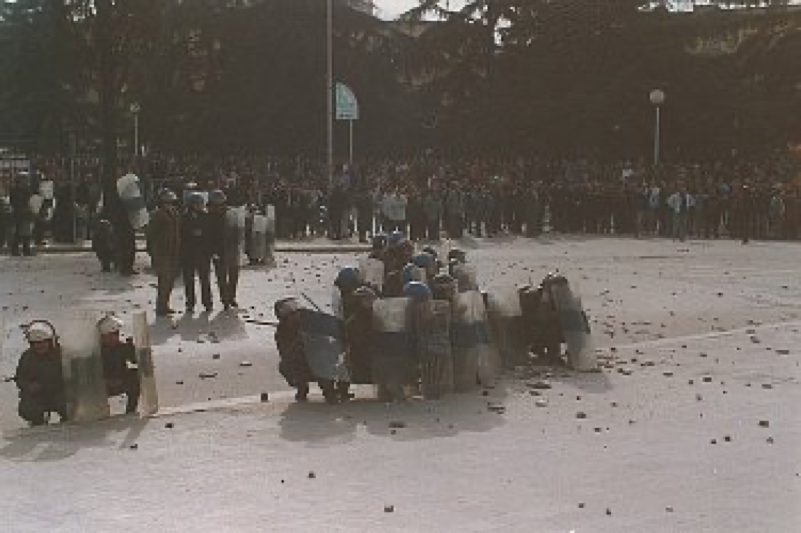 Protesters throwing stones at riot police during the 1997 unrest in Albania.