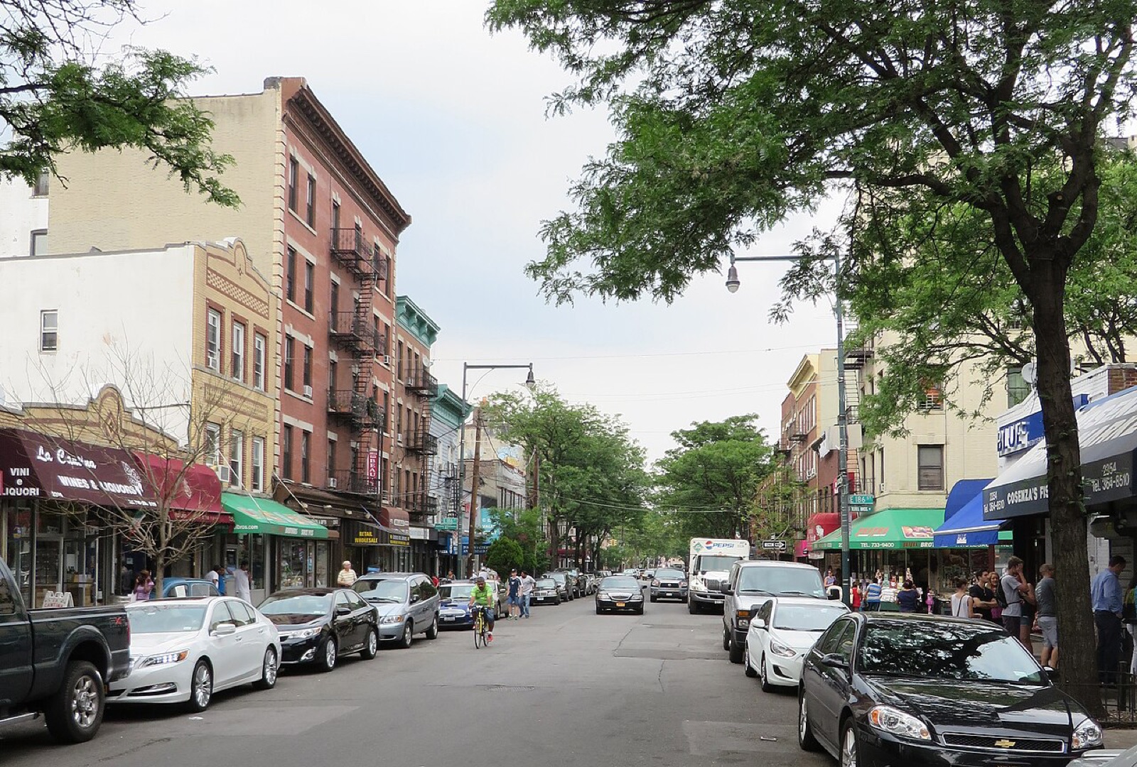 Arthur Avenue between 184th and 186th Streets in the Bronx — the commercial spine of Belmont, shared by Albanian and Italian-American businesses.