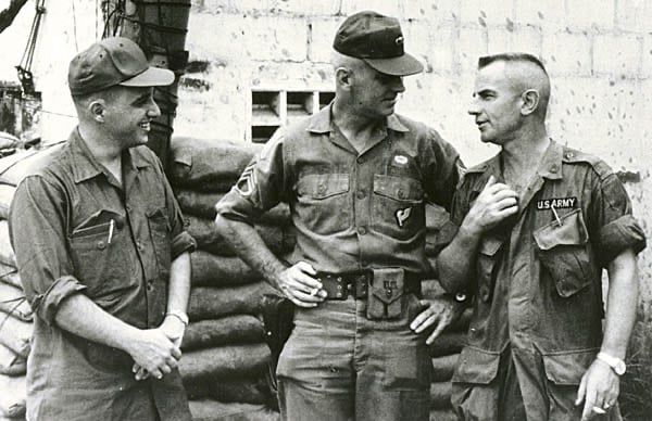 Charles C. Moskos (left) speaking with US Army personnel during a 1967 trip to Vietnam.
