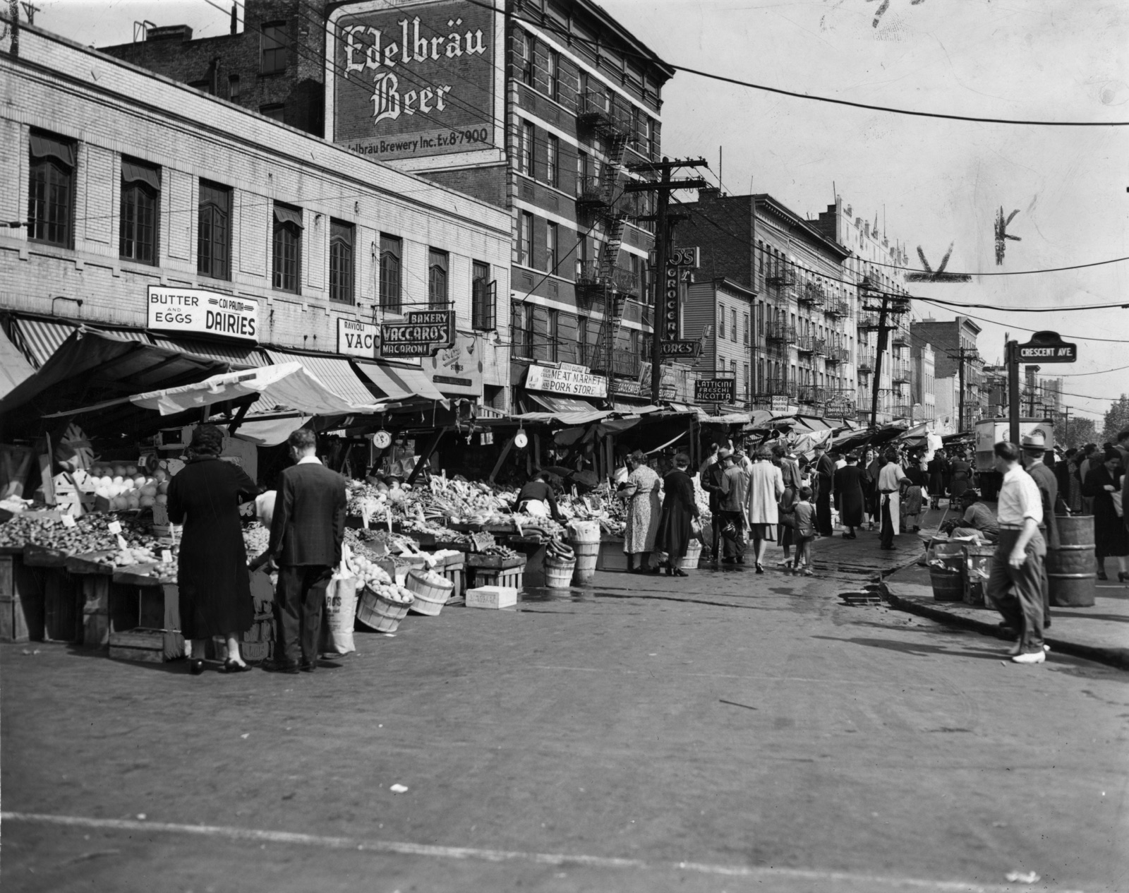 The Italian pushcart market on Arthur Avenue in 1940 — the commercial spine that Albanian families joined a generation later, working in Italian-owned restaurants and groceries before opening their own.