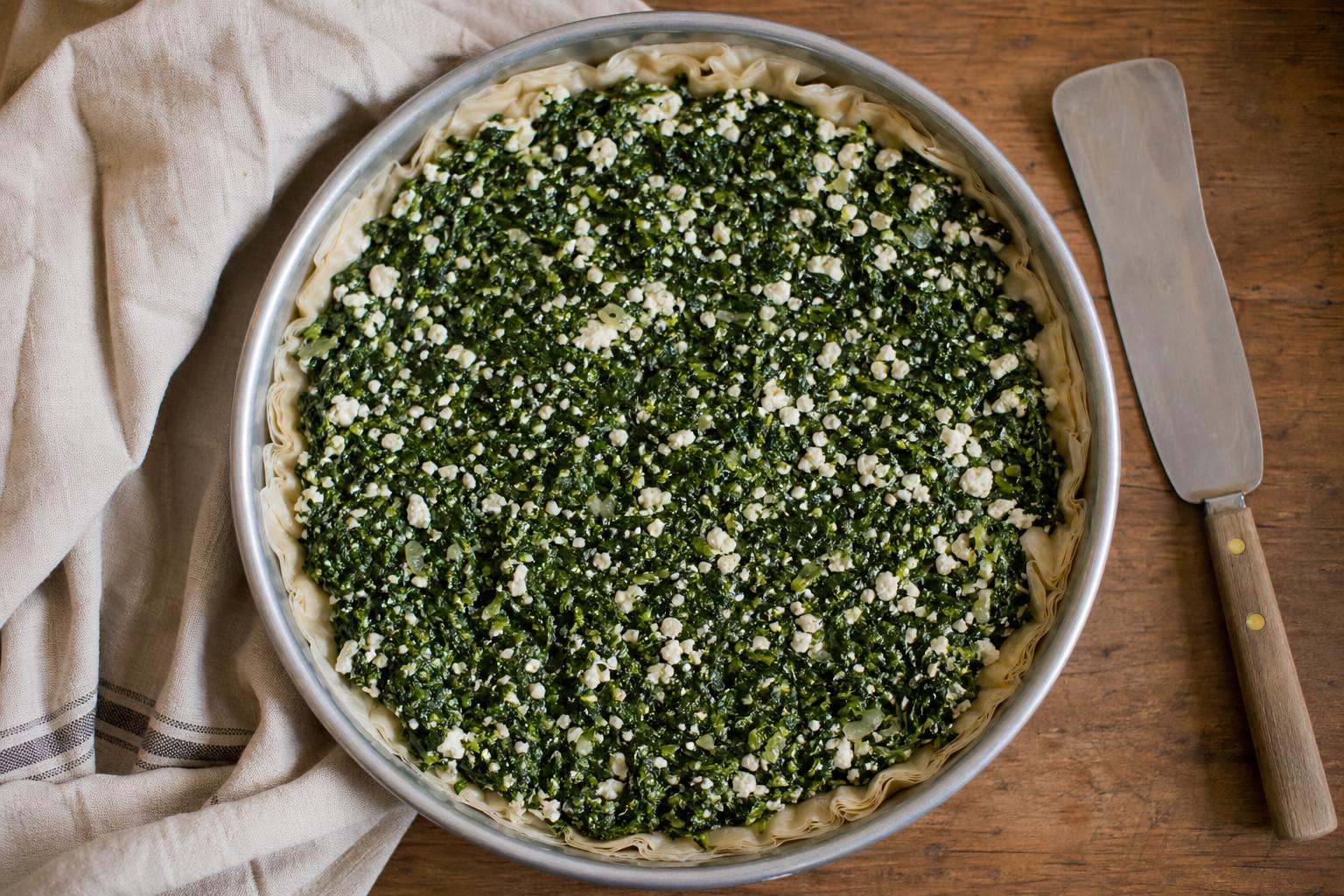 Spinach-cheese filling spread evenly across the layered filo