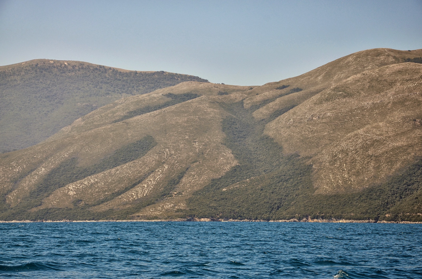 The Karaburun Peninsula seen from the Bay of Vlore — the type of remote Albanian shoreline used for the first sea-borne landings.